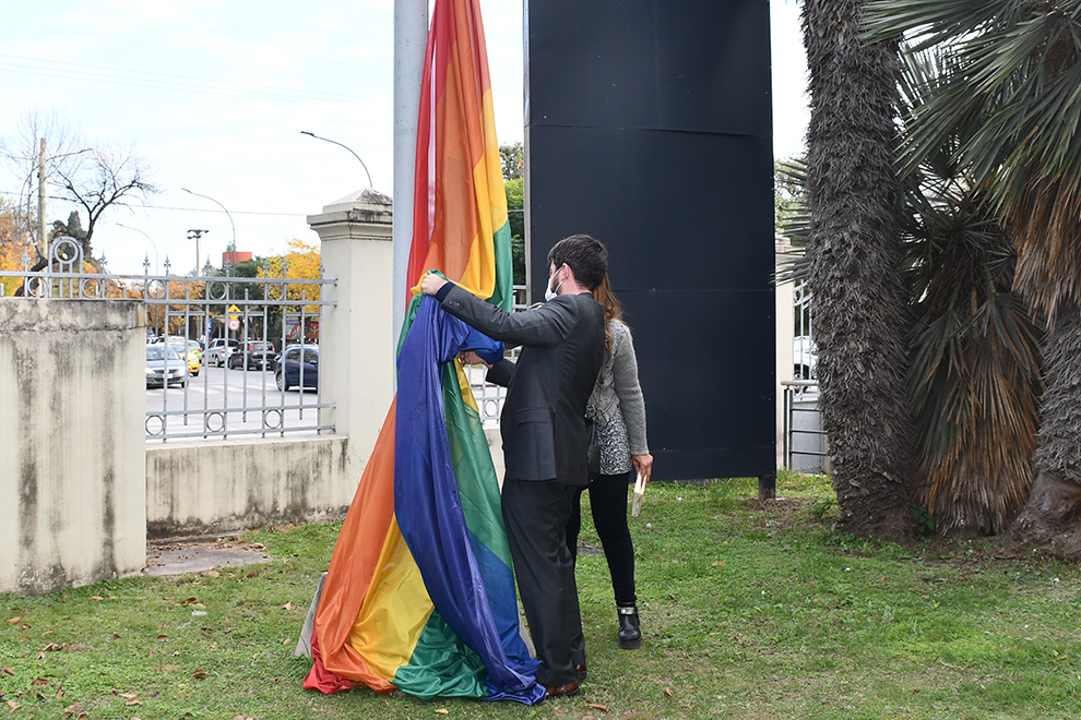 El secretario de DDHH, Calixto Angunlo iza la bandera con Eugenia Agostini, funcionaria de la Universidad Provincial